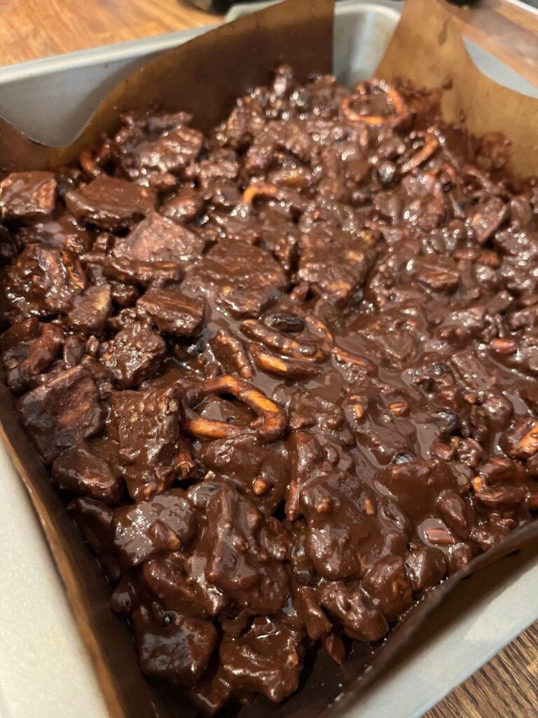 chocolate coated mixture in a lined baking tin